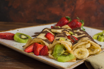 Healthy crepes with fruits, banana, kiwi and strawberry. Healthy french breakfast