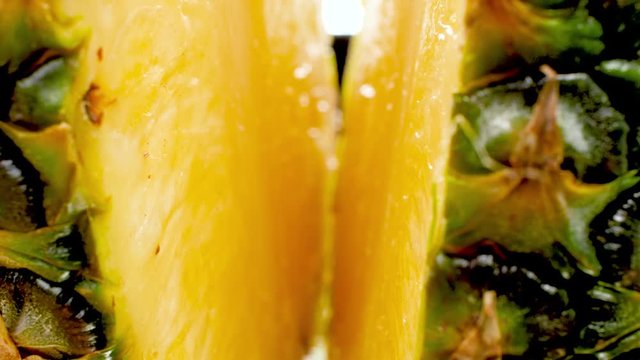 4k closeup dolly video of fresh tasty pineapple cut in two halves. Perfect abstract shot for organic food and healthy nutrition. Tropical fruits