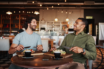 Friends enjoying italian brischetta food in cafe with coffee while laughing during conversation