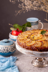 French sweet pie tart tatin apple cake upside down  over on gray concrete background. Top view