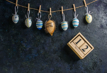 Easter holiday card concept with eggs on blue background with copy space