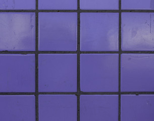 Small purple weathered and damaged tiles wall background texture