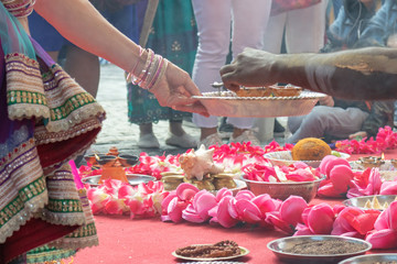 Wedding ceremony, traditional indian hindu marriage ritual with red flowers and attributes