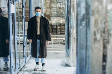 Man in the street wearing protective masks.