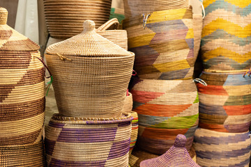 Large hand-made colored baskets in an African market