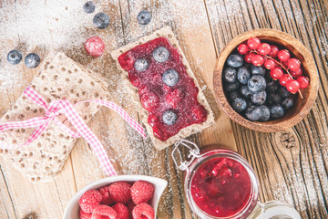 Fototapeta na wymiar Pastry appetizers with blueberries, cranberries and raspberries.