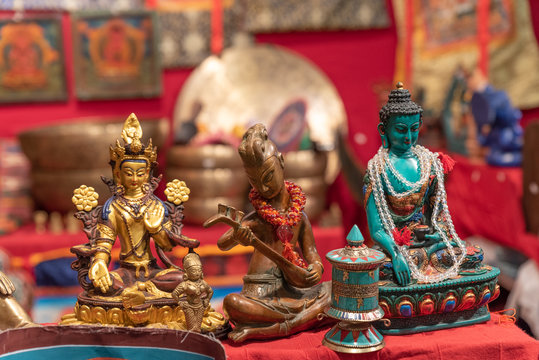 Three different statuettes depicting the Buddha in an ethnic market