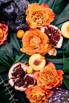 Lush still life arrangement of variety of colorful fruits and flowers