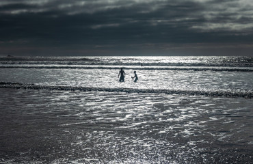 Two kids playing on the beach