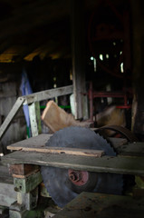 circular saw in traditional sawmill on wooden desk in the penunmbra.