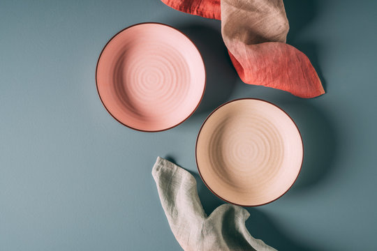 Still life of pastel colored ceramic dishes with ombre linens