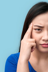 Freestyle. Chinese woman standing isolated on grey having headache wincing unhappy close-up