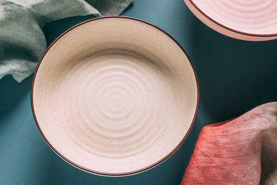 Still life of pastel colored ceramic dishes with ombre linens