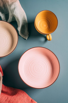 Still life of pastel colored ceramic dishes with ombre linens