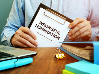Employee holds papers about wrongful termination.