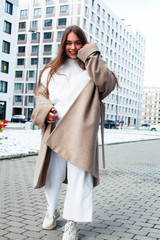Obraz premium young pretty teenage girl posing cheerful happy smiling wearing street style outside in europe city, lifestyle people concept
