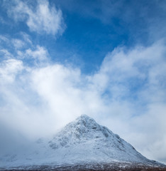 Fototapeta na wymiar buachaille etive mor in glencoe and rannoch moor shot in winter showing fresh white snow on the mountain in the argyll region of the highlands of scotland