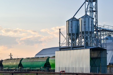 Loading railway carriages with grain at grain elevator. Copy space.