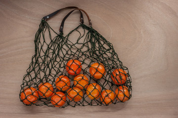 mandarins in green net bag zero waste concept