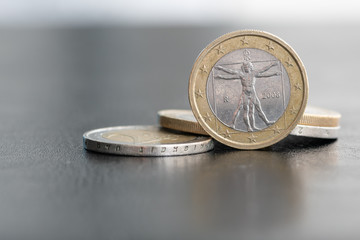Close up of a one euro coin on blurred background showing the Vitruvian Man, a drawing by Leonardo...
