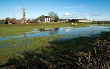 Fototapeta na wymiar Farm with flood water on fields