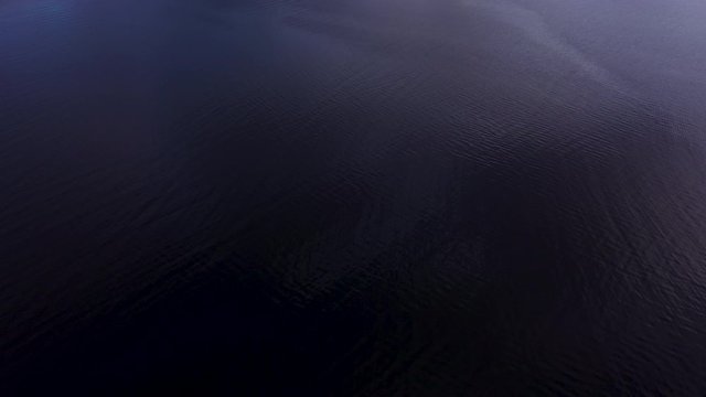 aerial drone footage of winter in glencoe and and loch leven in the argyll region of the highlands of scotland showing clear bright white snow on the mountains of glencoe and the surrounding region