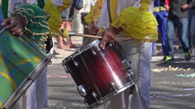 Drummer plays samba on the drum, at the carnival, slow motion, closeup.