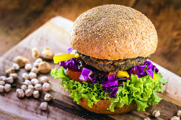 vegan burger made from various vegetables, corn, tomatoes, onion, red cabbage and peppers. Concept...