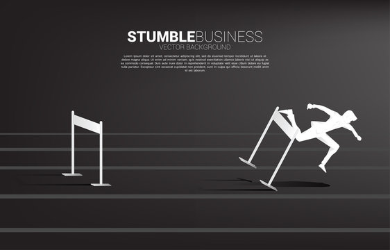 Silhouette of businessman stumbling during across hurdles obstacle. Concept for fail and accidental business