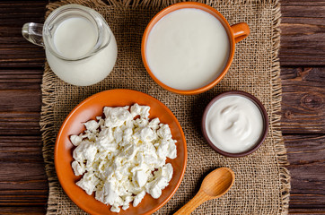 Homemade fermented milk products - kefir, cottage cheese on a wooden background