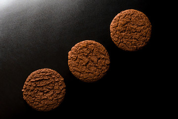 Chocolate chip cookies on dark old wooden table with place for text., freshly baked. Selective Focus with Copy space.