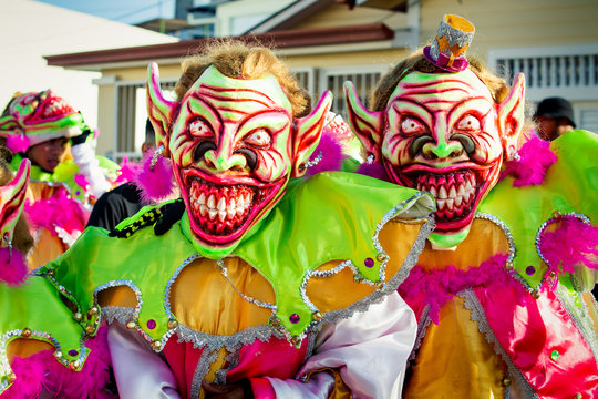 closeup two men in scary clowns costumes pose for photo at dominican carnival