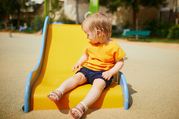 Fototapeta na wymiar Adorable little girl on playground on a sunny day