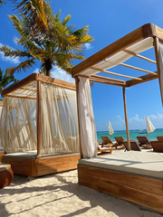 Canopy beds on a tropical beach 