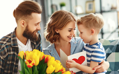 happy mother's day! father and child congratulate mother on holiday  .