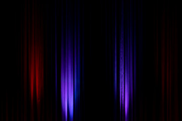 Black backdrop with red and purple lights in a theater