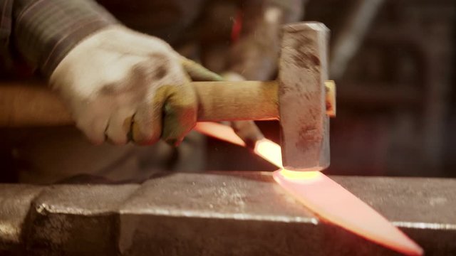 Forging a knife out of the hot metal - hitting with a hammer