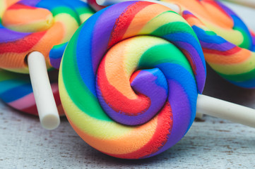 Lollipops on white wooden background. colorful candies
