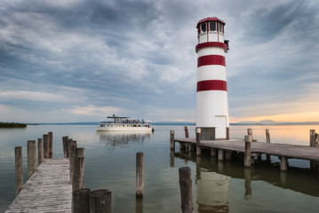 Fototapeta na wymiar Lighthouse with Passenger Boat at Sunset in Podersdorf at Neusiedl Lake, Austria