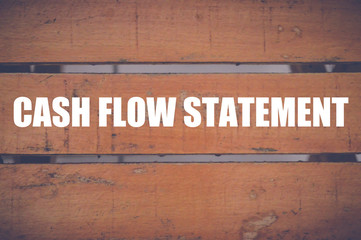cash flow statement written on wood background