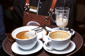 Used coffee cups on a tray
