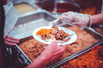 Feeding the poor to hands of a beggar, Poverty concept