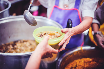 Feeding the poor to hands of a beggar, Poverty concept