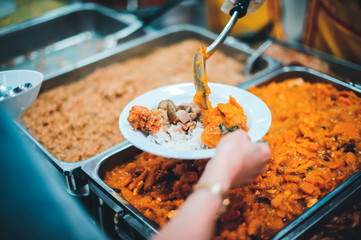 Volunteers are sharing food to needy hungry people.