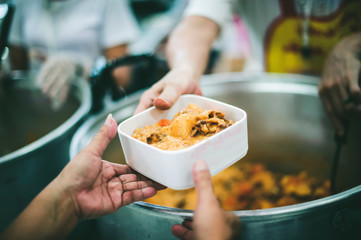 The hands of the poor request food donations donated by philanthropists.