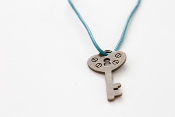 closeup heart shape key necklace on white background