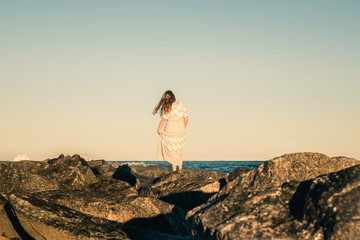 Girl Looking Out Over the Ocean from Rocks