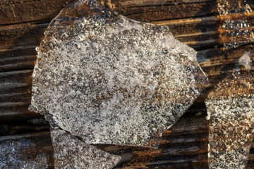 Broken chunks of ice on a wooden boardwalk