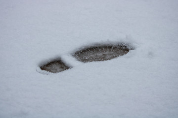 Footstep in snow on gloomy day