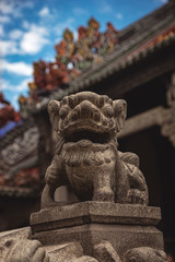 Close up of Fu dog in ancient temple. Chinese culture, art in the roof. Asian architecture. Exotic Tavel and Destination